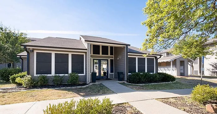 Charming apartment exterior with a modern design, lush landscaping, and abundant natural light creating an inviting first impression.