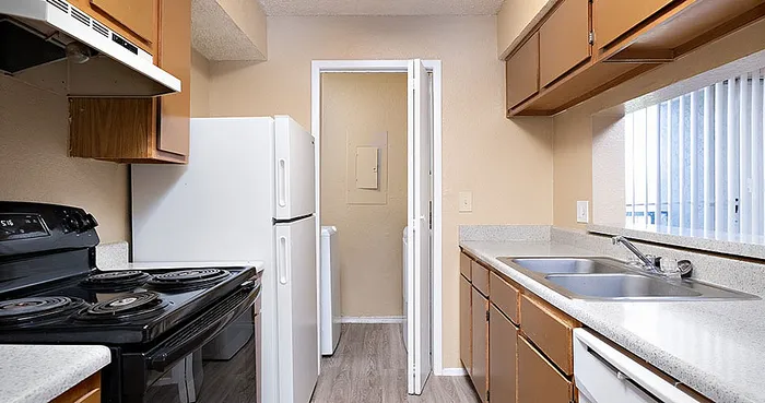 Bright kitchen with modern appliances, sleek countertops, and ample cabinet space.