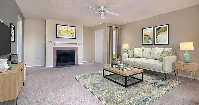 Inviting living room with a cozy fireplace, elegant decor, and plush carpeting, perfect for relaxation and entertainment.