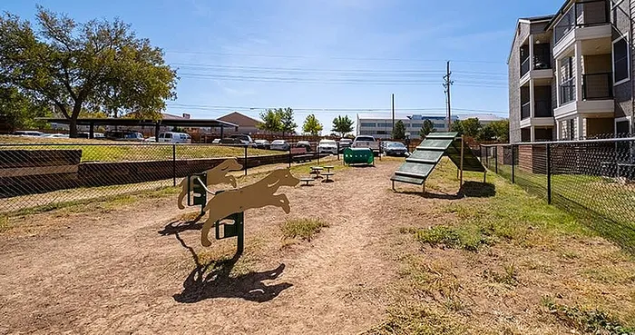 Inviting dog park with agility equipment and scenic surroundings in a vibrant apartment community.