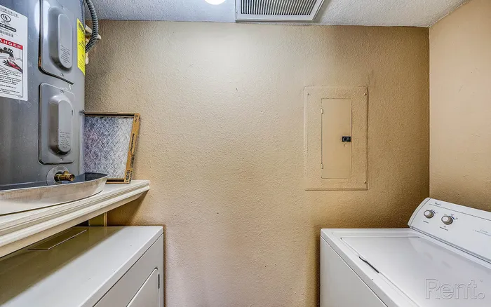 Convenient in-unit laundry area featuring modern washer and dryer setup, ideal for hassle-free living.