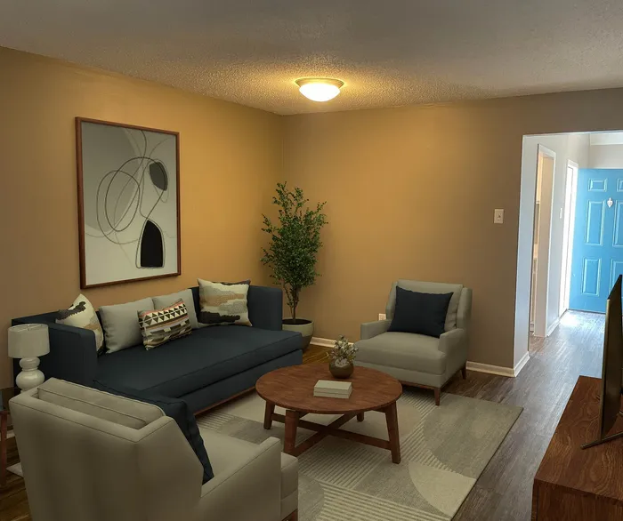 Cozy living room with stylish decor, featuring a plush navy sofa, modern armchairs, and a wooden coffee table under warm lighting.