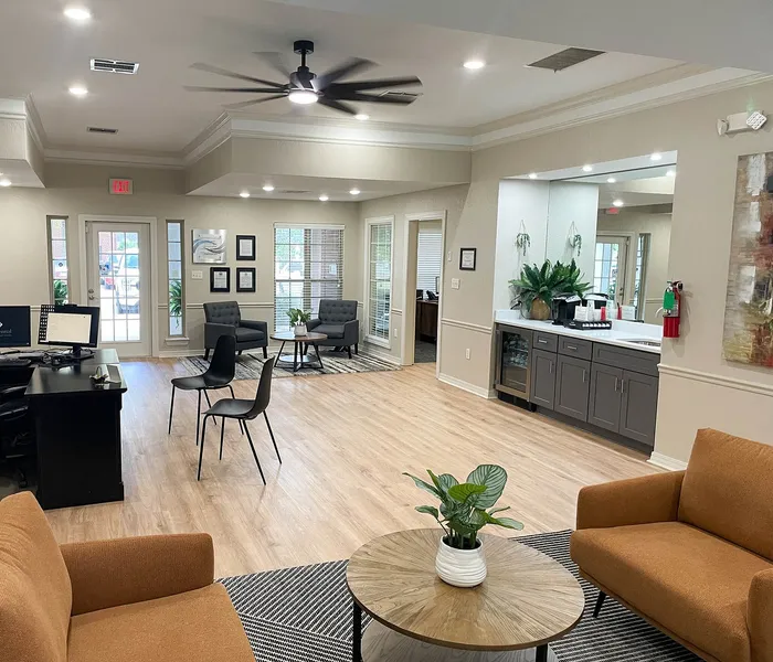 Bright and welcoming open-concept office space with modern furniture, cozy seating area, and stylish decor.