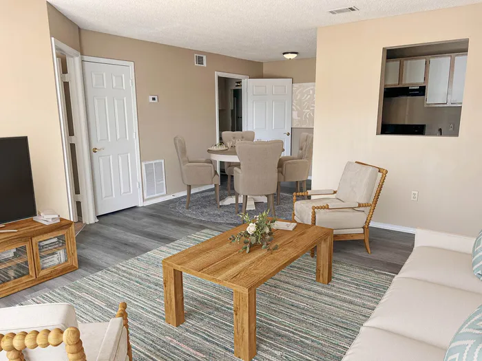 Inviting living room with stylish wooden furniture, cozy seating area, and a chic dining space, perfect for relaxation and entertaining.