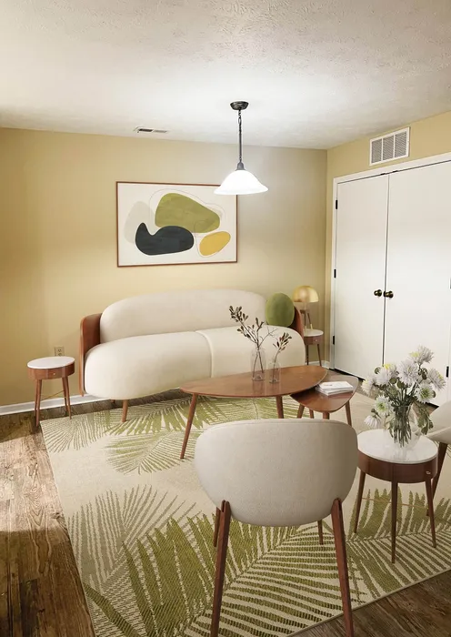Charming living room with modern furniture, stylish abstract artwork, and elegant decor elements creating a cozy atmosphere.