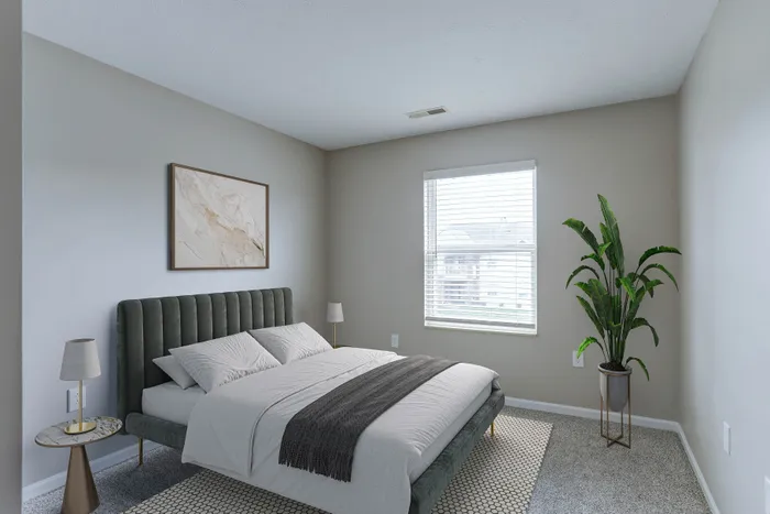 Inviting bedroom with a plush bed, modern decor, and large window for abundant natural light.