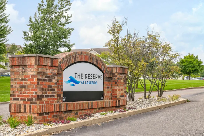 Charming entrance sign for The Reserve at Lakeside, surrounded by lush greenery and well-maintained landscaping, offering a welcoming community ambiance.