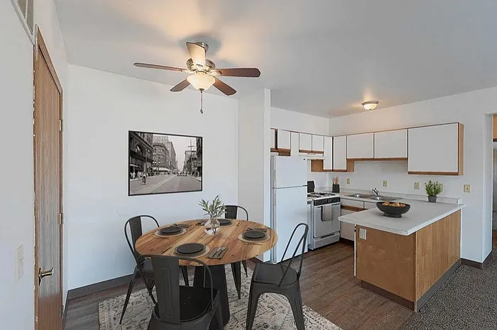 Charming kitchen and dining area with modern cabinetry, a cozy wooden dining table set, and warm lighting, perfect for a welcoming home atmosphere.