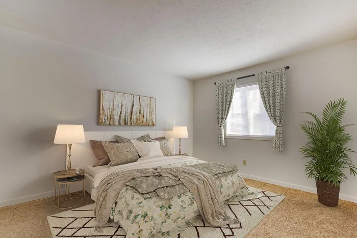 Inviting bedroom with elegant decor featuring a cozy bed, stylish nightstands, and lush greenery for a tranquil ambiance.