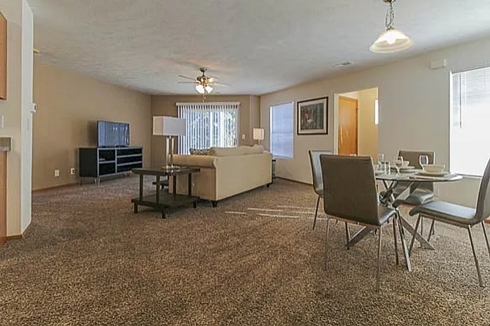 Bright and welcoming open-concept living room with a cozy dining area, perfect for entertaining.
