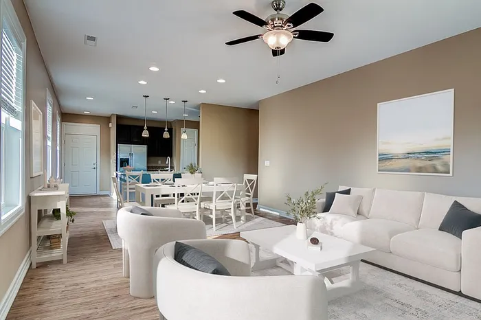 Elegant open-concept living and dining area featuring modern furniture, stylish lighting, and a serene color palette.