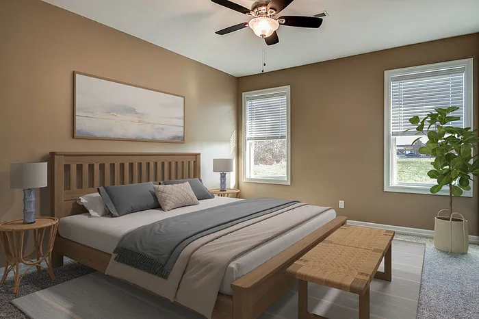 Inviting bedroom with cozy decor, featuring a comfortable bed, stylish ceiling fan, and large windows letting in natural light.