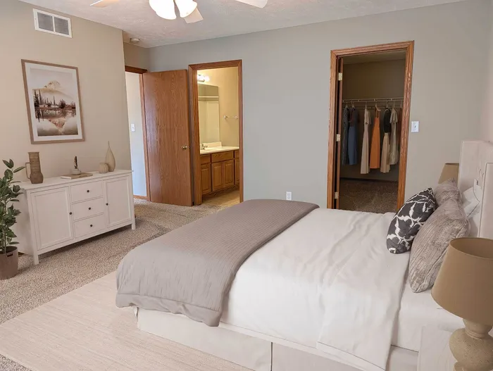 Inviting bedroom with elegant decor, featuring a plush bed, spacious walk-in closet, and en-suite bathroom for ultimate comfort.