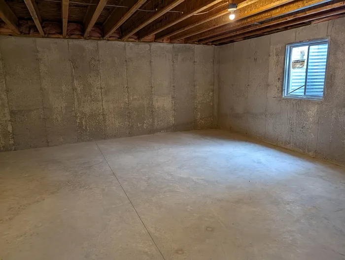 Spacious basement with natural light, offering potential for a cozy living area or customizable space.