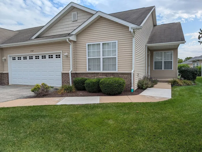 Charming suburban home with welcoming exterior, featuring a double garage, well-maintained garden, and quaint entryway.
