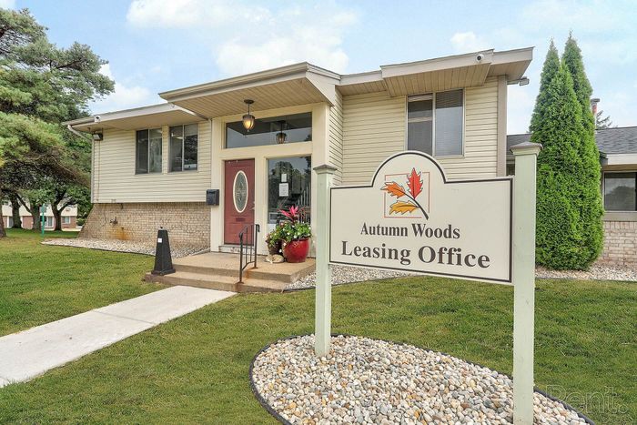 Inviting Autumn Woods Leasing Office with charming exterior and beautiful landscaping, perfect for your next home search.