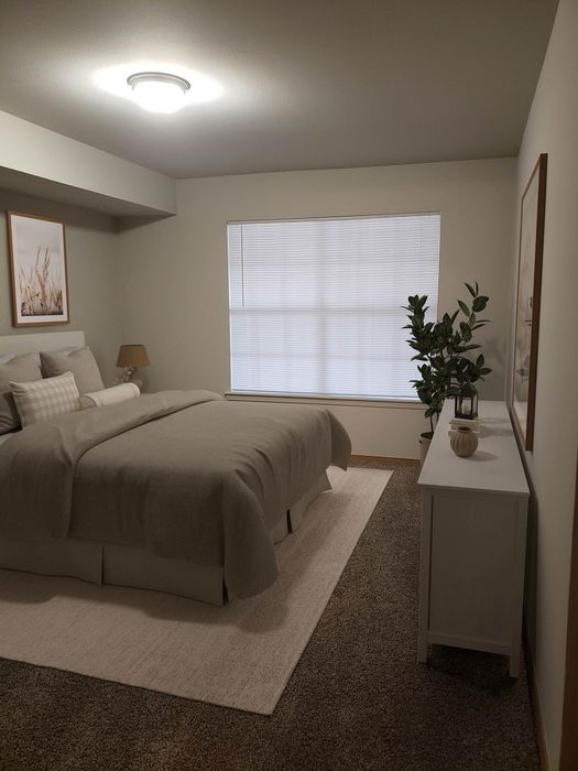 Inviting bedroom with cozy decor, featuring a plush bed, soft lighting, and elegant accents for a tranquil retreat.