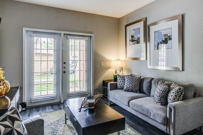 Chic living room featuring stylish furniture, modern decor, and large windows with natural light.