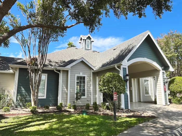 Charming modern house with a picturesque facade, surrounded by lush greenery and blue skies, offering a welcoming and serene atmosphere.