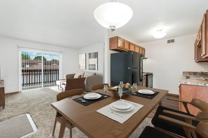 Inviting open-concept apartment with a bright living room, modern kitchen, and stylish dining area overlooking a scenic view.