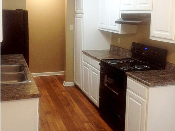 Charming kitchen with sleek countertops, modern appliances, and warm wood flooring, perfect for any home chef.