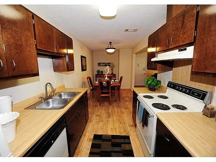 Inviting kitchen area with sleek cabinetry and adjacent dining area, perfect for entertaining and culinary exploration.