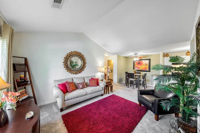 Inviting living space with plush seating, vibrant decor, and a cozy dining area, perfect for entertaining.