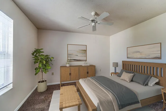 Elegant bedroom with cozy ambiance featuring a modern wooden bed, stylish decor, and abundant natural light.