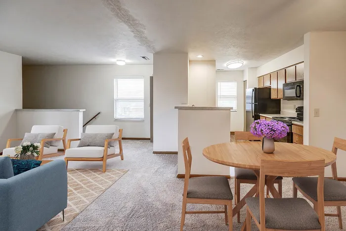 Inviting open-concept living space with cozy seating, spacious dining area, and modern kitchen, perfect for comfort and entertaining.