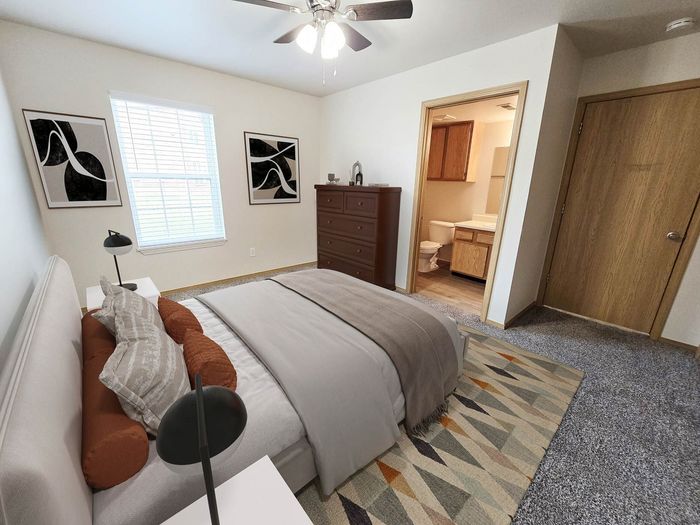 Inviting bedroom with elegant decor, featuring plush bedding, stylish artwork, and private access to a modern ensuite bathroom.
