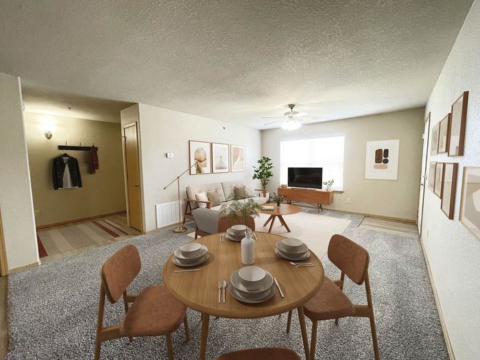 Inviting living space featuring modern decor, cozy dining area, and natural light in an open-concept apartment.