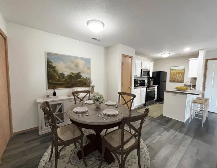 Charming open-concept kitchen and dining area with elegant wooden dining set, modern appliances, and inviting decor.