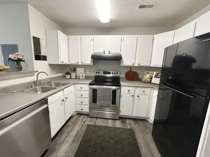 Sleek modern kitchen with stainless steel appliances, elegant white cabinetry, and stylish decor accents.
