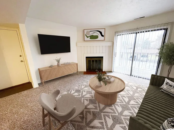 Contemporary living room with modern decor, featuring large windows, stylish furniture, and a cozy fireplace for a welcoming ambiance.
