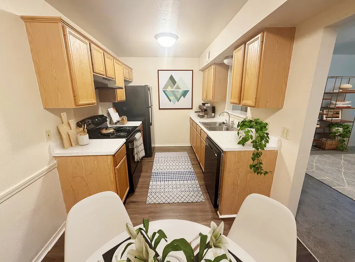 Inviting kitchen with warm wood cabinets, modern appliances, and stylish decor featuring a geometric art piece, perfect for culinary creativity.