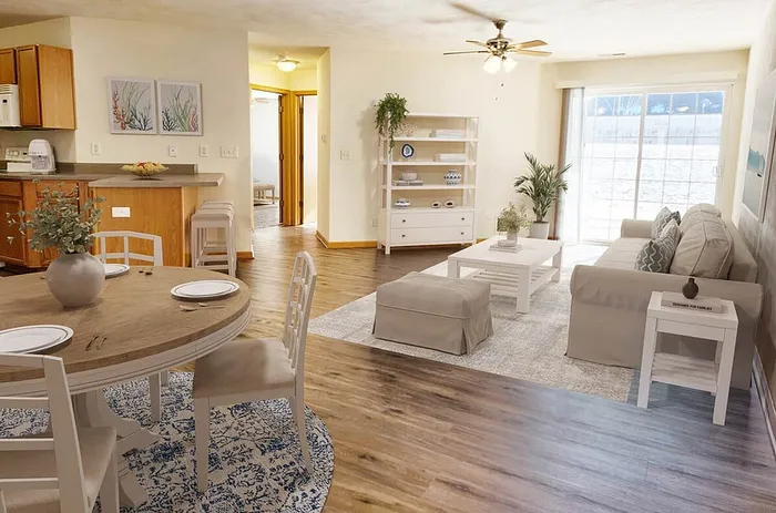 Bright and airy living-dining space featuring cozy seating, elegant wooden flooring, and abundant natural light from large sliding doors.
