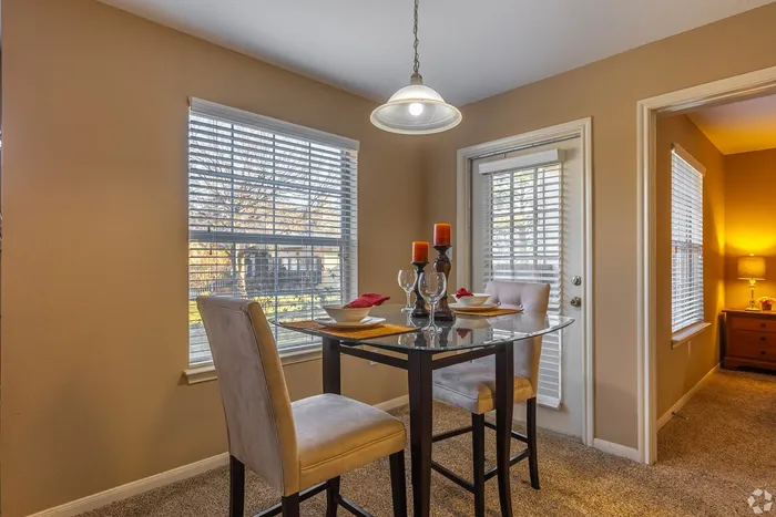 Cozy dining nook with elegant table setting, natural light, and a welcoming ambiance.