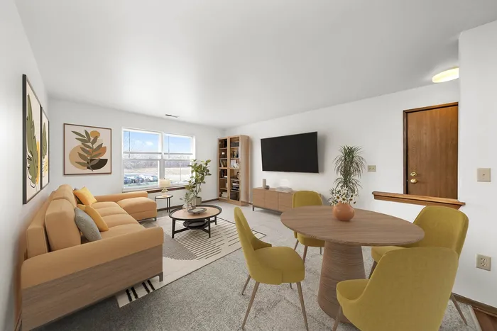 Bright and modern living room featuring a stylish orange sectional sofa, sleek wooden furniture, vibrant yellow dining chairs, and decorative plants, creating a cozy and inviting atmosphere.