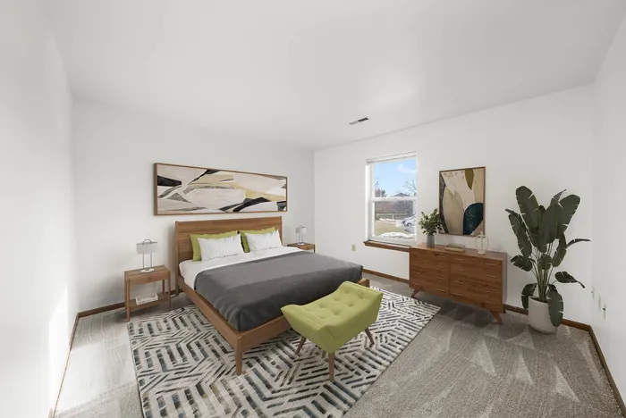 Bright and spacious bedroom with a modern wooden bed frame, geometric area rug, and large window offering natural light and scenic views.