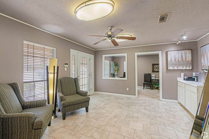 Inviting lobby area featuring elegant seating, contemporary lighting, and large windows welcoming natural light.