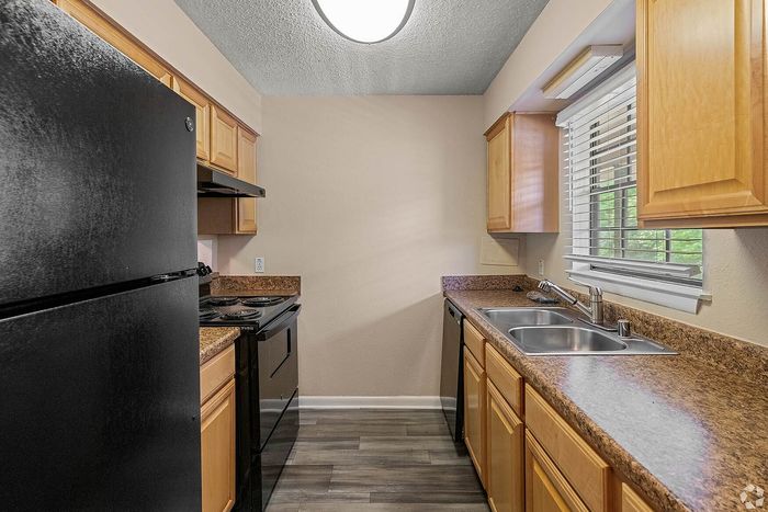 Charming kitchen with modern appliances, sleek countertops, and natural wood cabinetry. Ideal for culinary enthusiasts.