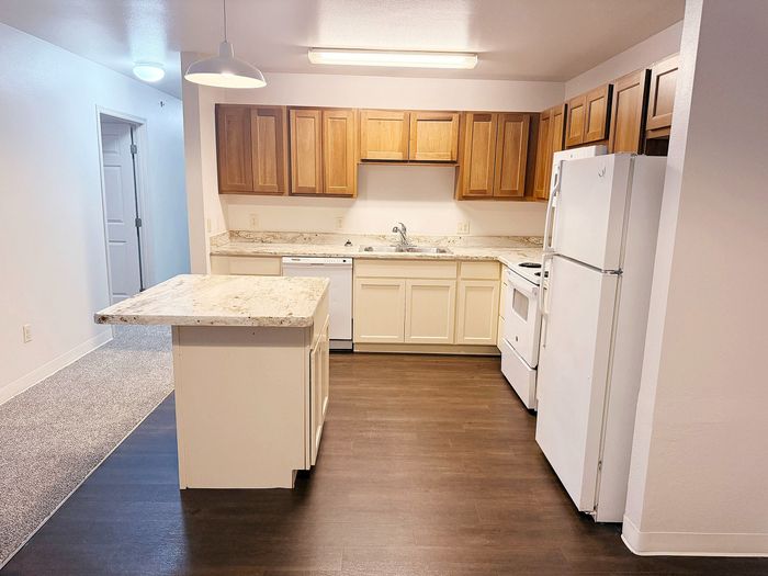 Inviting kitchen space featuring warm wood cabinets, a sleek island countertop, and modern appliances.