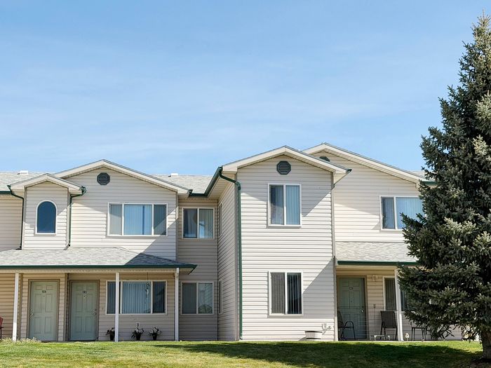 Charming duplex with bright windows and welcoming entryways, ideal for modern living in a serene neighborhood.