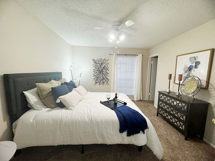 Inviting bedroom with a cozy bed, elegant decor, and soft lighting creating a warm atmosphere.
