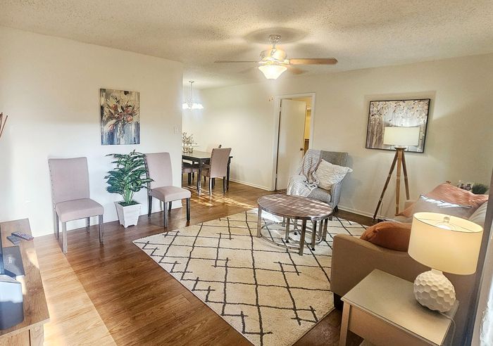 Bright and inviting living area featuring elegant seating, modern decor, and abundant natural light.