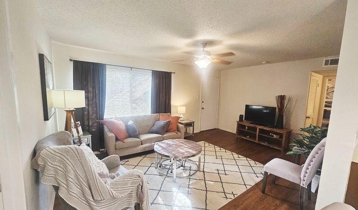 Inviting living room with cozy seating, modern decor, and warm natural light, perfect for relaxation and socializing.