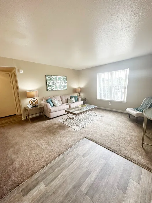 Bright and inviting living room with elegant decor, plush sofa, and natural light streaming through large windows, perfect for relaxation and entertaining.