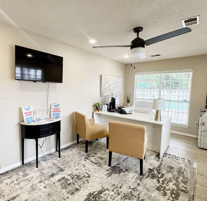 Inviting office space with modern decor, plush seating, and a scenic view through large windows.