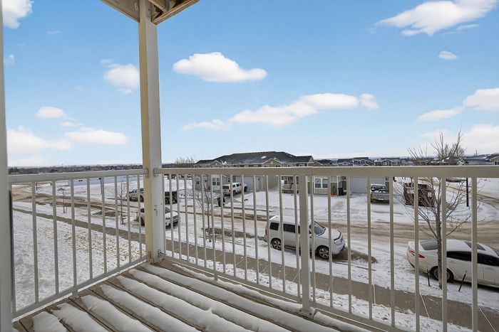 Charming balcony view overlooking a serene snowy neighborhood, perfect for enjoying peaceful winter mornings.