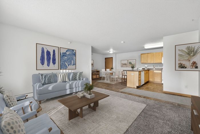 Inviting open-plan living area with stylish furniture, a cozy dining space, and a modern kitchen perfect for entertaining.